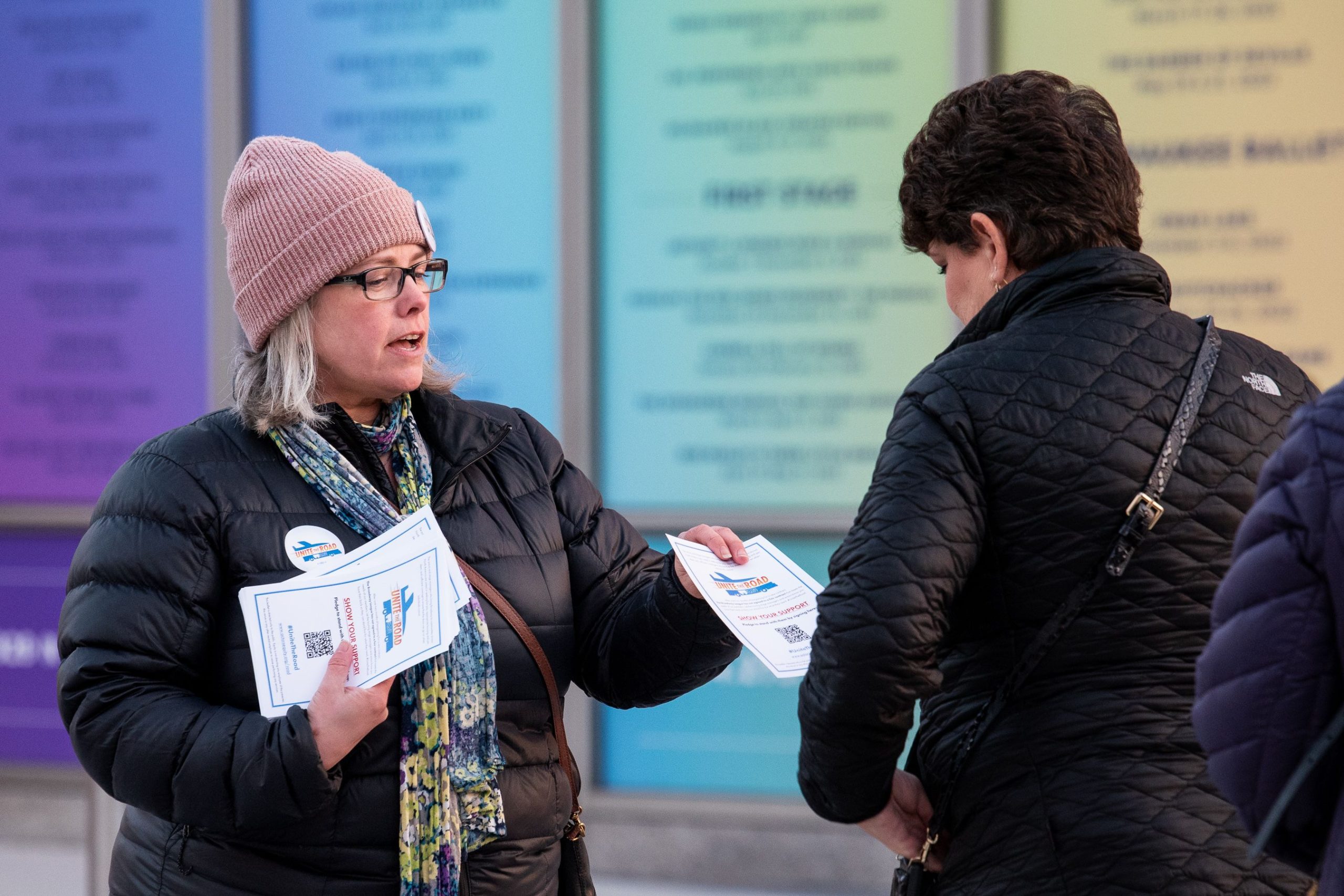 Show-captain-Nicole-Olson-distributes-fliers-outside-of-a-theater-in-Milwaukee.-Photo-by-Michael-Courier-scaled